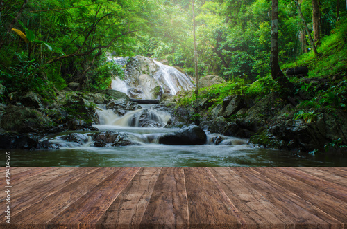 Fototapeta Naklejka Na Ścianę i Meble -  Wood floor perspective and natural mountain waterfall