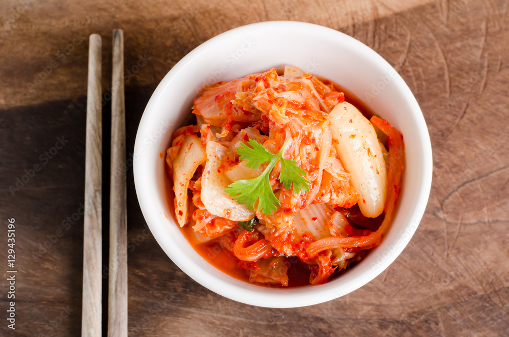 Kimchi cabbage (Korean food) in a bowl on wooden background Kimchi cabbage (Korean food) in a bowl on wooden background