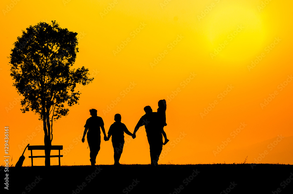 silhouette family over grass background at sunset