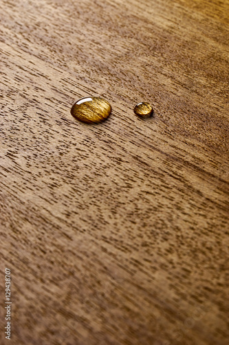 Water droplets on a wooden surface