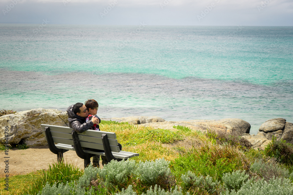 Traveler couple relaxing meditation with serene view seascape of Cape Leeuwin, along the Indian Ocean ,Augusta Western Australia .