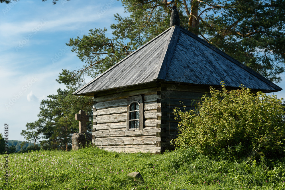 Fototapeta premium The small wooden house on grass hill with a copy space