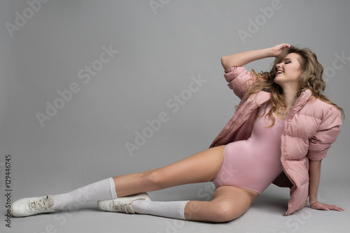 Fashion Studio shot of leggy attractive model on grey background photo