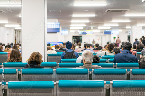 Unidentified people waiting at the airplane boarding gates at airport