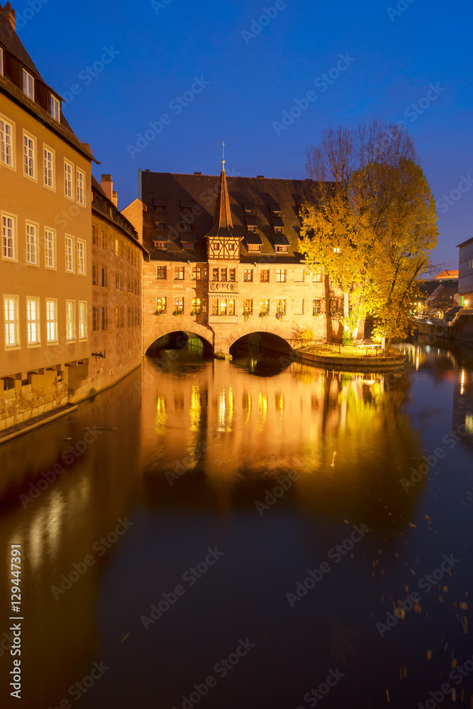 Heilig-Geist-Spital (Hospice of the Holy Spirit) at night, Old town of Nuremberg, Germany