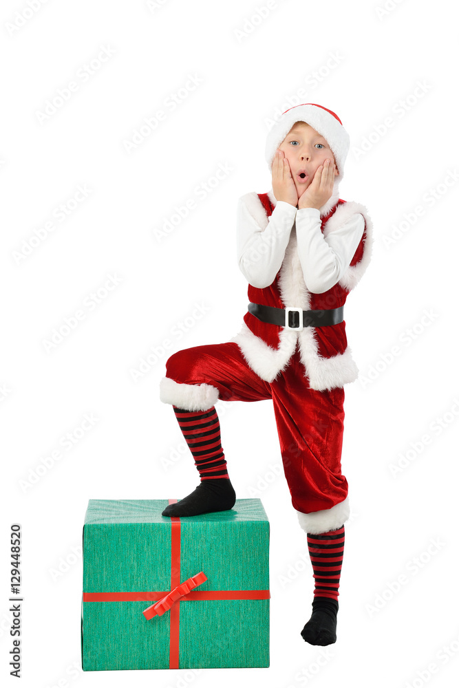 Adorable surprised boy in santa clothes with Christmas big gift box . Isolated white background. Adorable surprised boy in santa clothes with Christmas big gift box . Isolated white background.