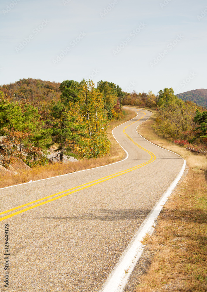 Talimena scenic byway winding on the crest of the mountain, with trees in fall colors