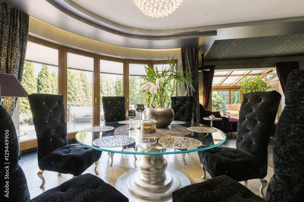 Fototapeta premium Luxurious dining room with glass table