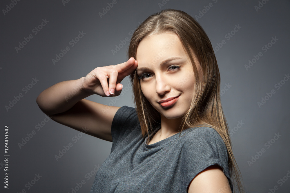 Fototapeta premium Woman with two fingers up to head