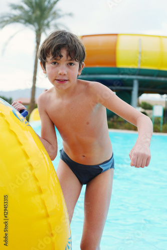 preteen little boy in open air aqua park