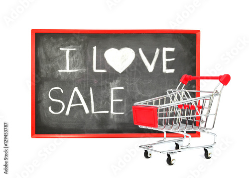 Shopping cart with chalk written word "I Love Sale" on black boa