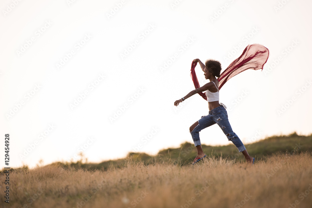 black girl dances outdoors in a meadow black girl dances outdoors in a meadow