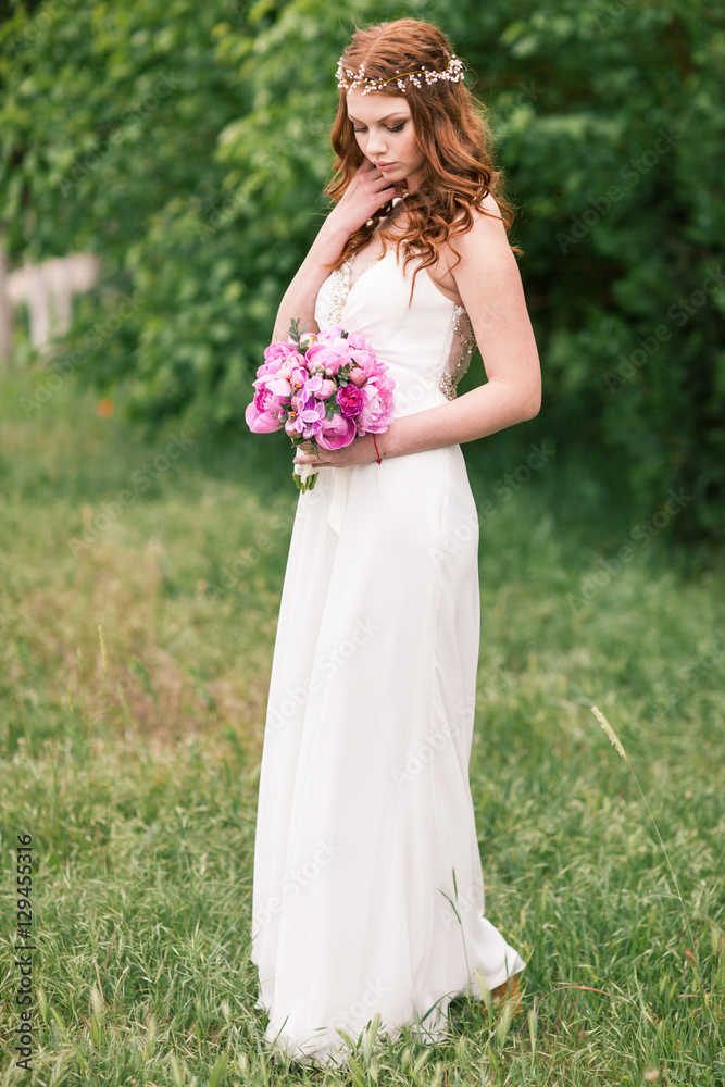 Beautiful bride in white dress in the garden Beautiful bride in white dress in the garden