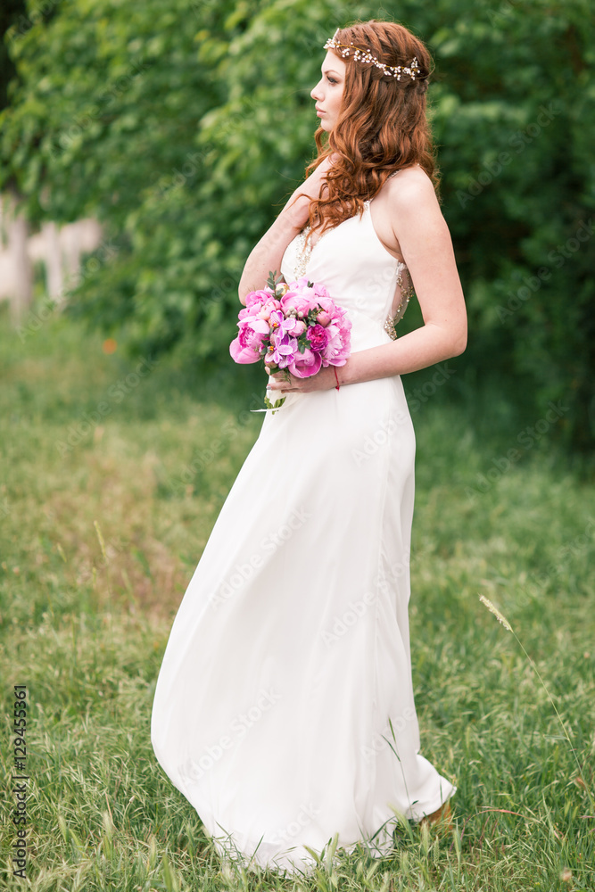 Beautiful bride in white dress in the garden Beautiful bride in white dress in the garden