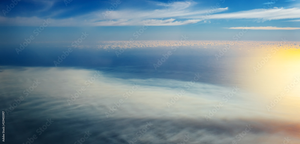 Clouds and sky as seen through window of an aircraft