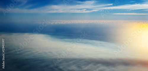 Clouds and sky as seen through window of an aircraft