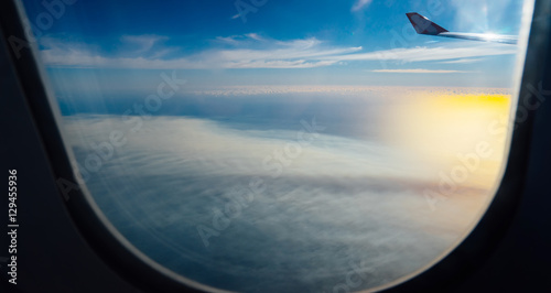 Clouds and sky as seen through window of an aircraft © jamesteohart