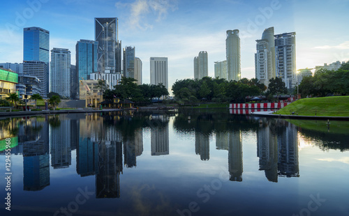 city at a lake with beautiful sky reflection during sunrise .