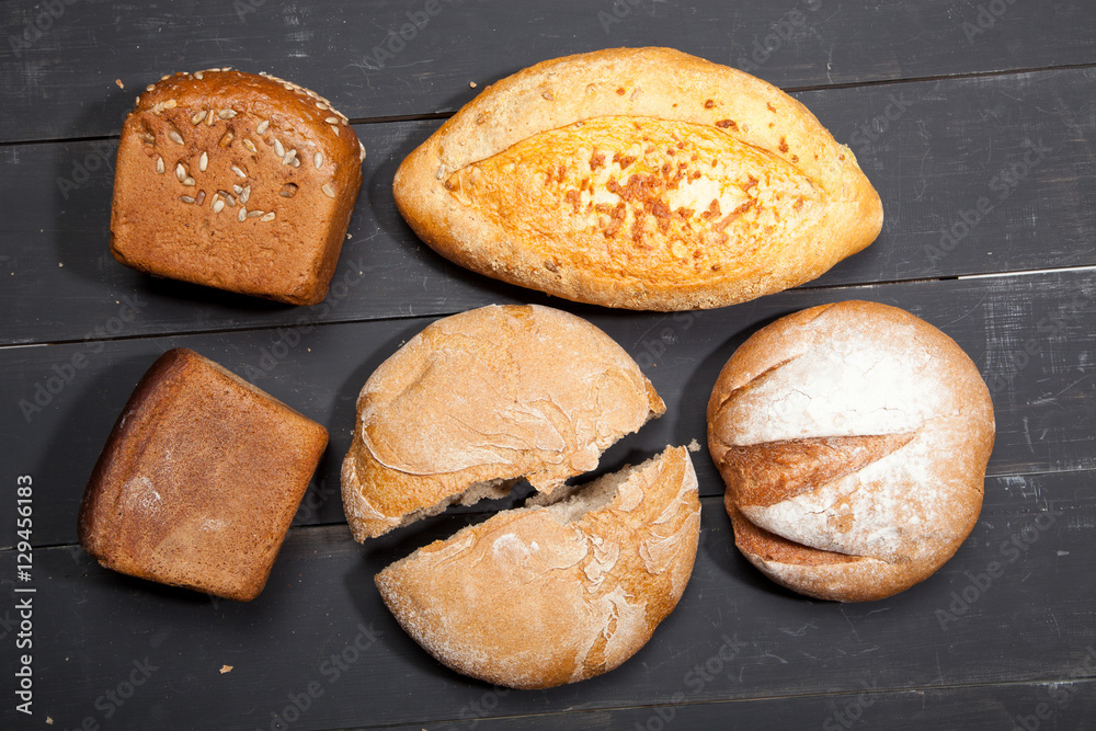 Homemade bread on a black wooden background