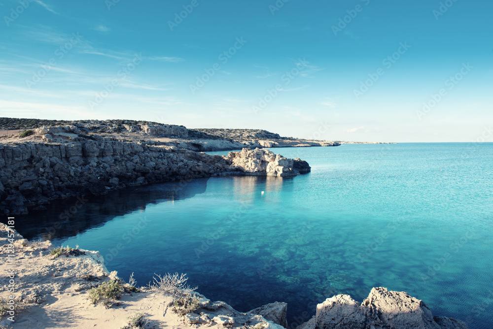 Sea coast with rocks, lagoon and blue water, natural outdoor vacation background