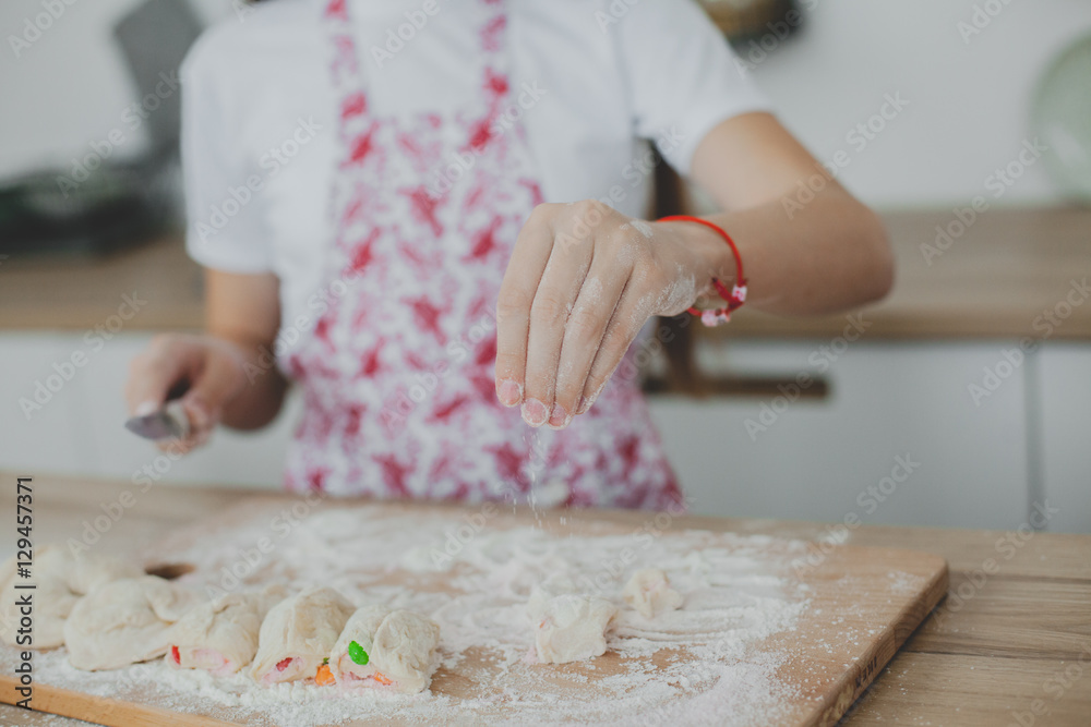 Mother with her daughter are preparing the buns Mother with her daughter are preparing the buns