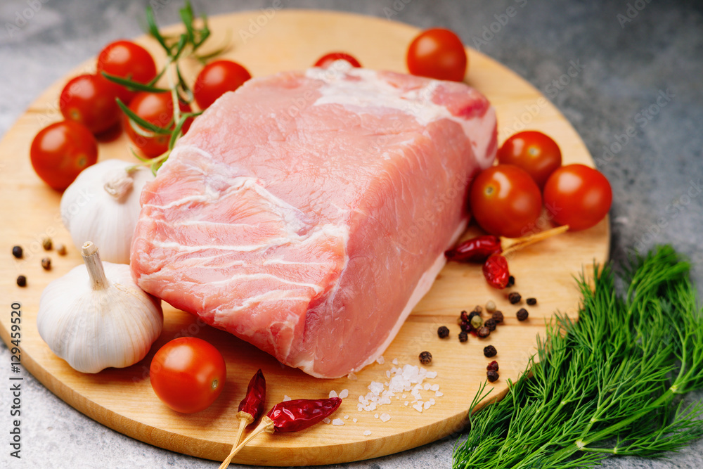 Raw pork on cutting board and vegetables Raw pork on cutting board and vegetables