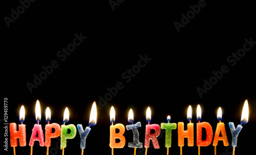 Canvas Print Colorful of happy birthday candle with flame lighting on the black screen