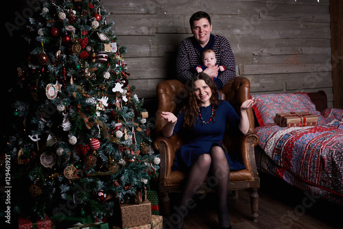 happy family posing under christmas tree 