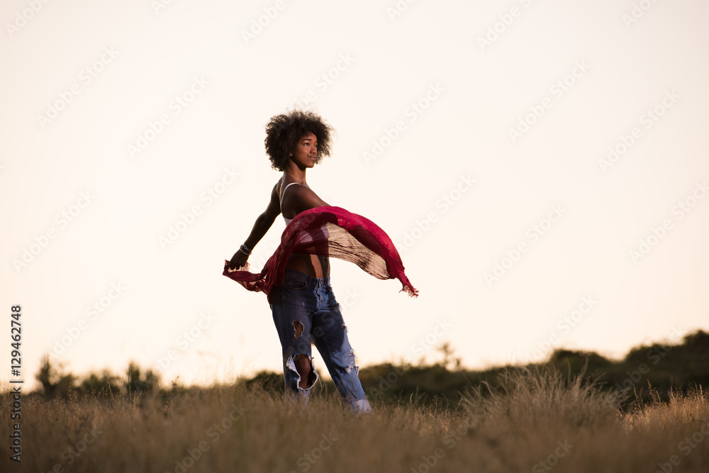 black girl dances outdoors in a meadow black girl dances outdoors in a meadow