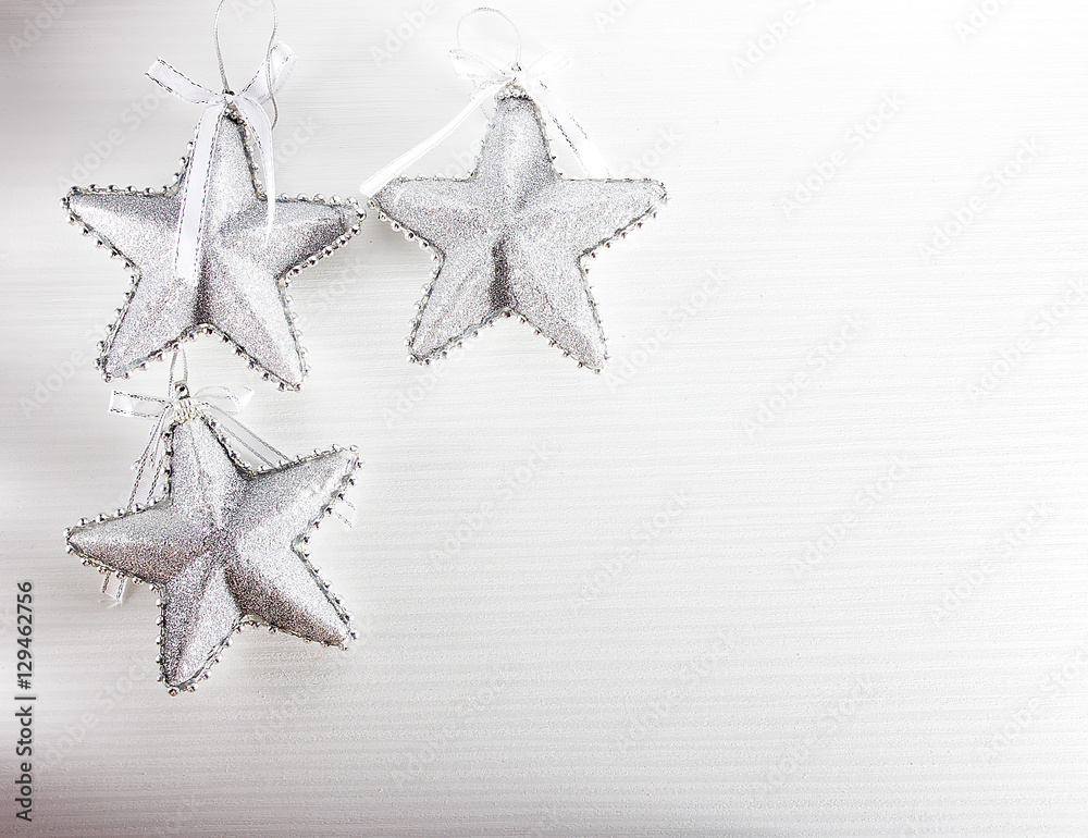 Silver Christmas decorations stars on white wooden background Silver Christmas decorations stars on white wooden background