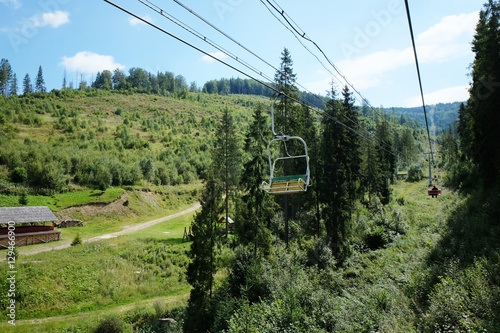 View of ski lift and green wood mountain forest