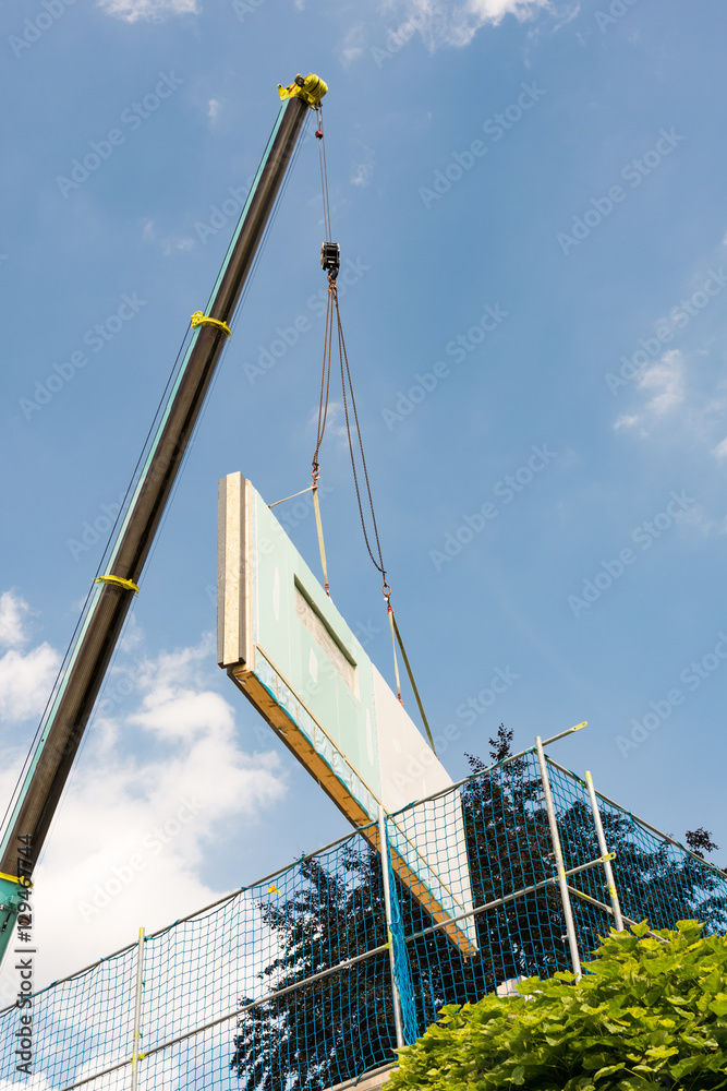 Fototapeta premium Assembling a prefabricated house