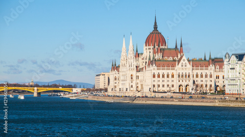 Daytime view of historical building of Hungarian Parliament, aka Orszaghaz, with typical symmetrical architecture and central dome on Danube River embankment in Budapest, Hungary, Europe. It is © pyty