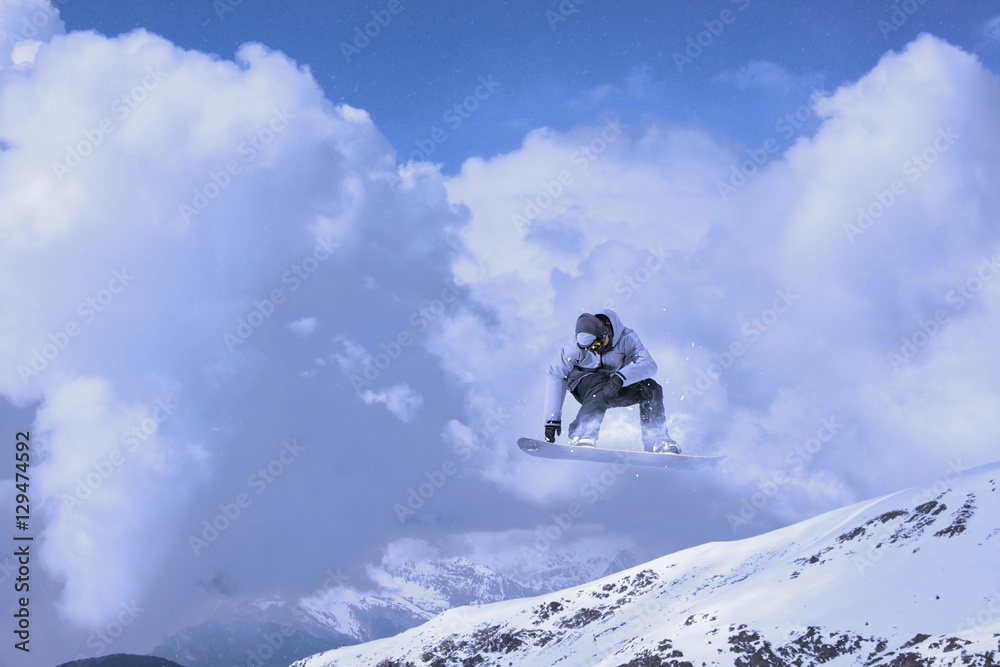 Snowboard rider jumping on mountains. Extreme sport.