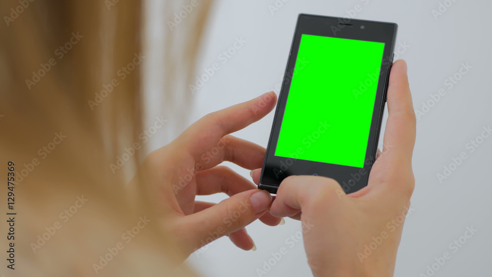 Woman using vertical smartphone with green screen. Close up shot of woman's hands with mobile Close up shot of woman's hands with mobile. White background Woman using vertical smartphone with green screen. Close up shot of woman's hands with mobile Close up shot of woman's hands with mobile. White background