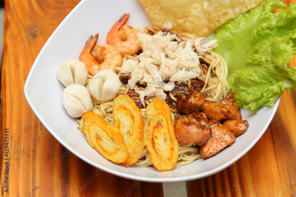 Crab noodles black pepper with prawn shrimp and vegetable in white bowl Crab noodles black pepper with prawn shrimp and vegetable in white bowl