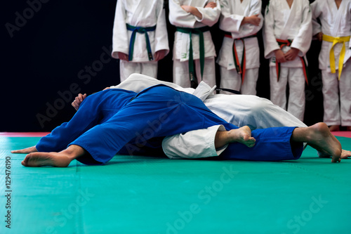 Black belt in Judo holds down his opponent 