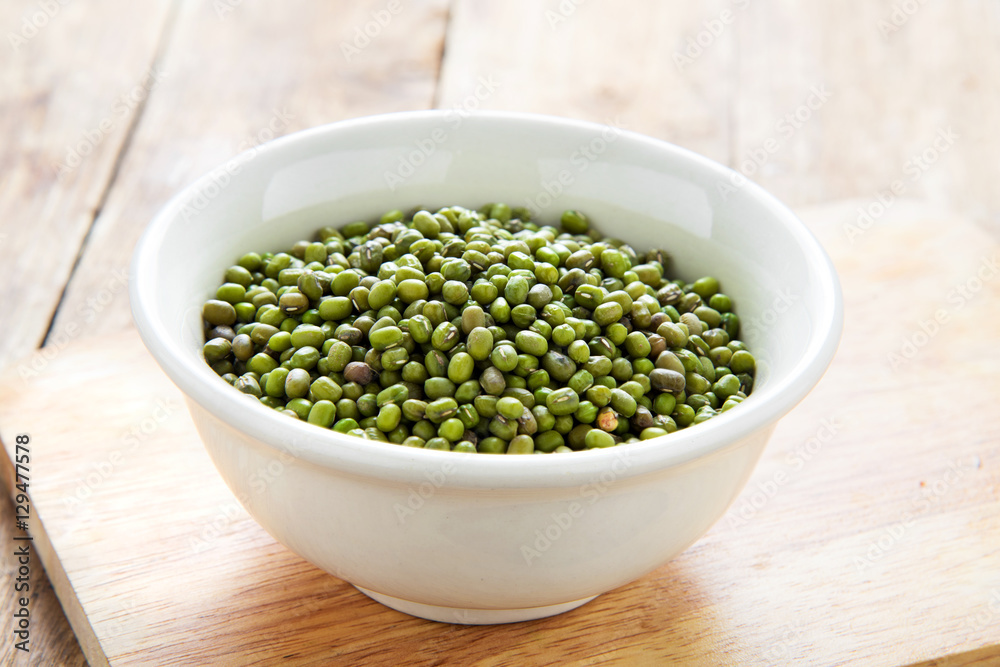 Fresh green peas in bowl on wooden table Fresh green peas in bowl on wooden table
