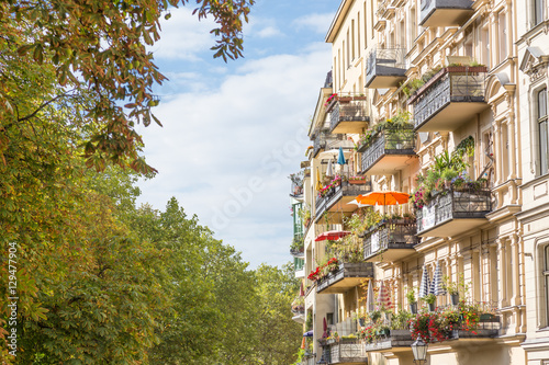 Traditional European residential house with balconys with colorful flowers and flowerpots. Kreuzberg neighborhood, Berlin, Germany, photo
