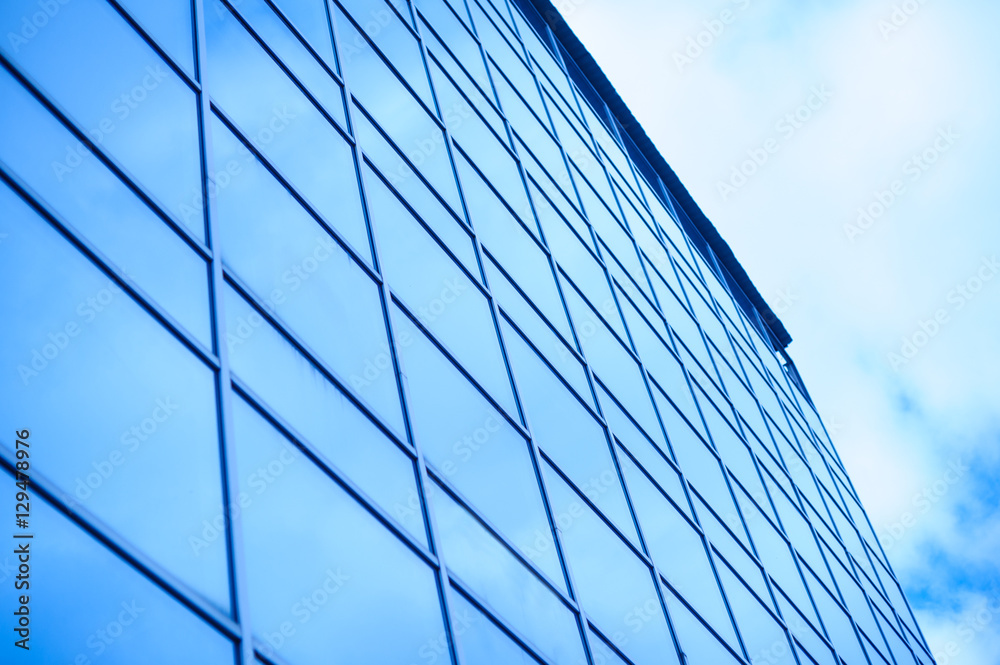 glass office building on a background of the sky