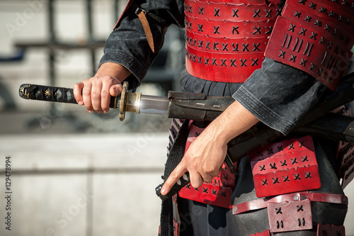 Samurai unsheathed his traditional katana photo