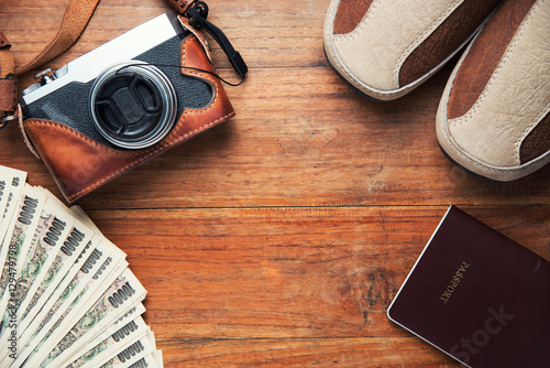 Travel accessories including money and digital camera. Passport and shoes. Ready to go travel concept. Top view with copy space.