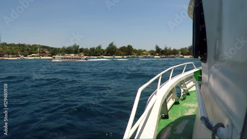 View from motor boat on coastline with vacationers. photo