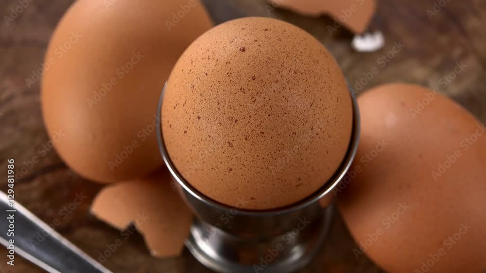 Boiled Eggs rotating on a wooden plate (not loopable; 4K)..