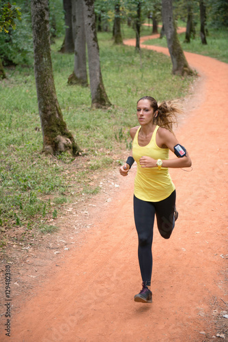 Fototapeta Naklejka Na Ścianę i Meble -  Running in forest. Female running in park