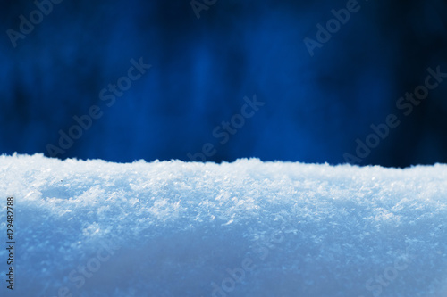 Snow bank against evening bokeh background. Selective focus. Toned image. © Studio Dagdagaz