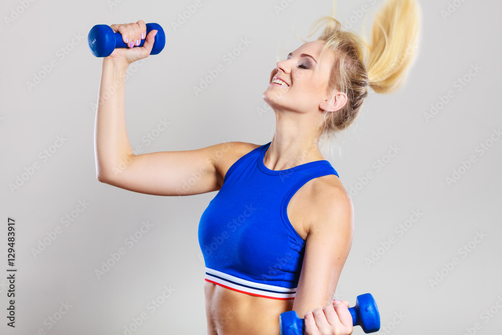 Fit woman lifting dumbbells weights Fit woman lifting dumbbells weights