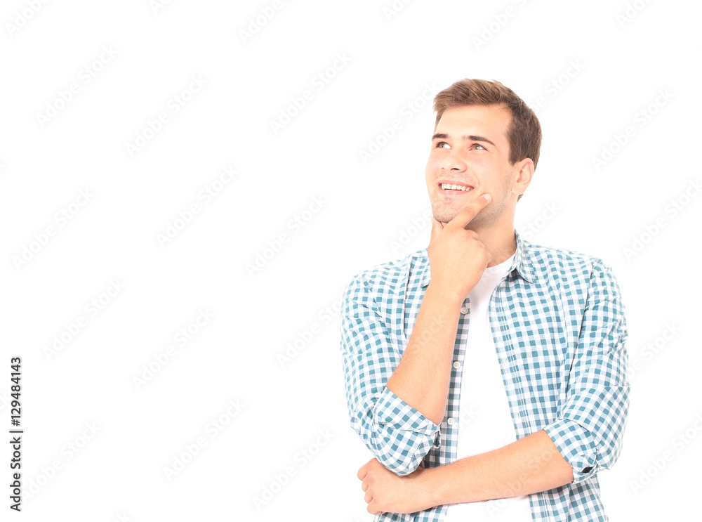 Portrait of smart smiling thinking young man in plaid shirt on white background. Copy space Portrait of smart smiling thinking young man in plaid shirt on white background. Copy space