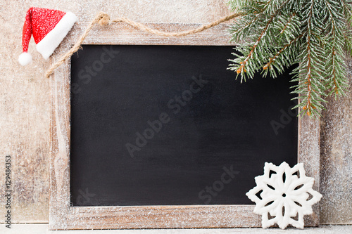 Christmas chalkboard with decoration. Santa hat, stars, Wooden