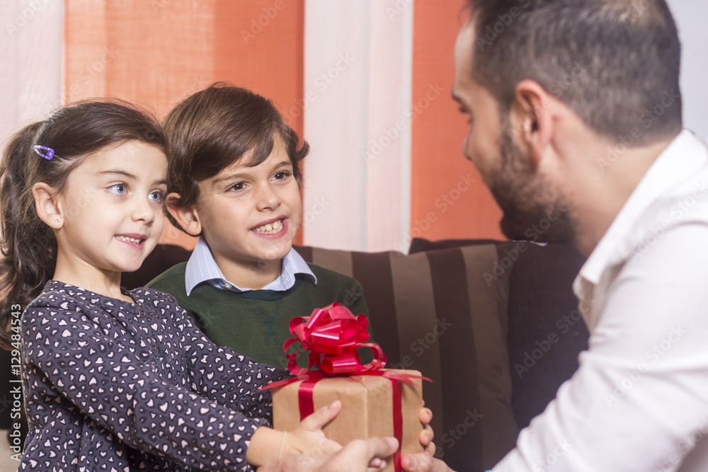 Children giving present to their father